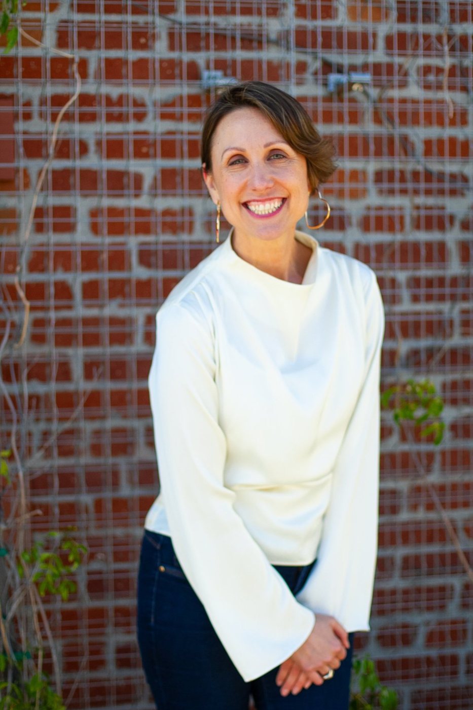 Portrait of Helene Cornell in front of a brick wall